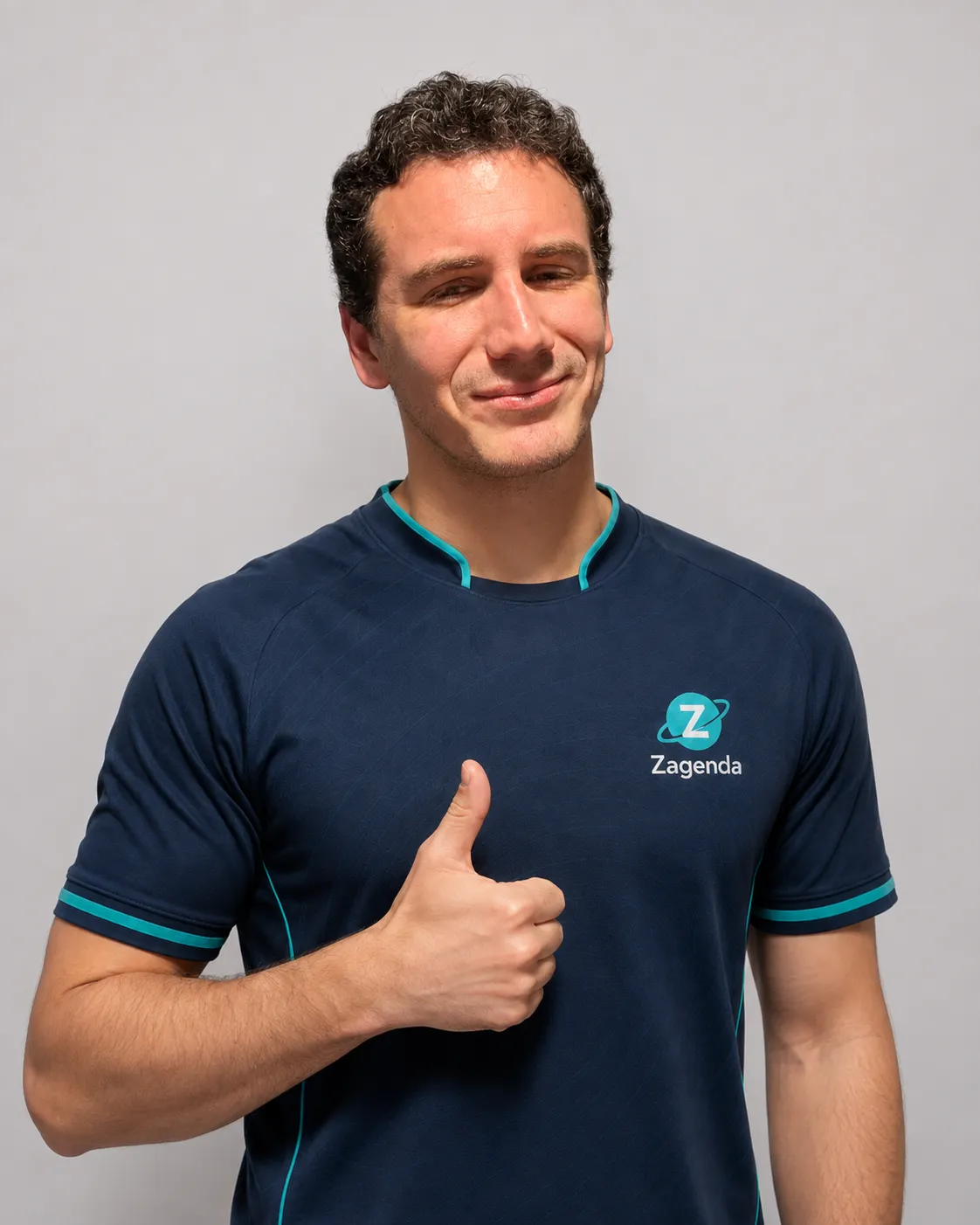 Gonzalo, del equipo de Zagenda, sonriendo con el pulgar en alto y la polera de la marca